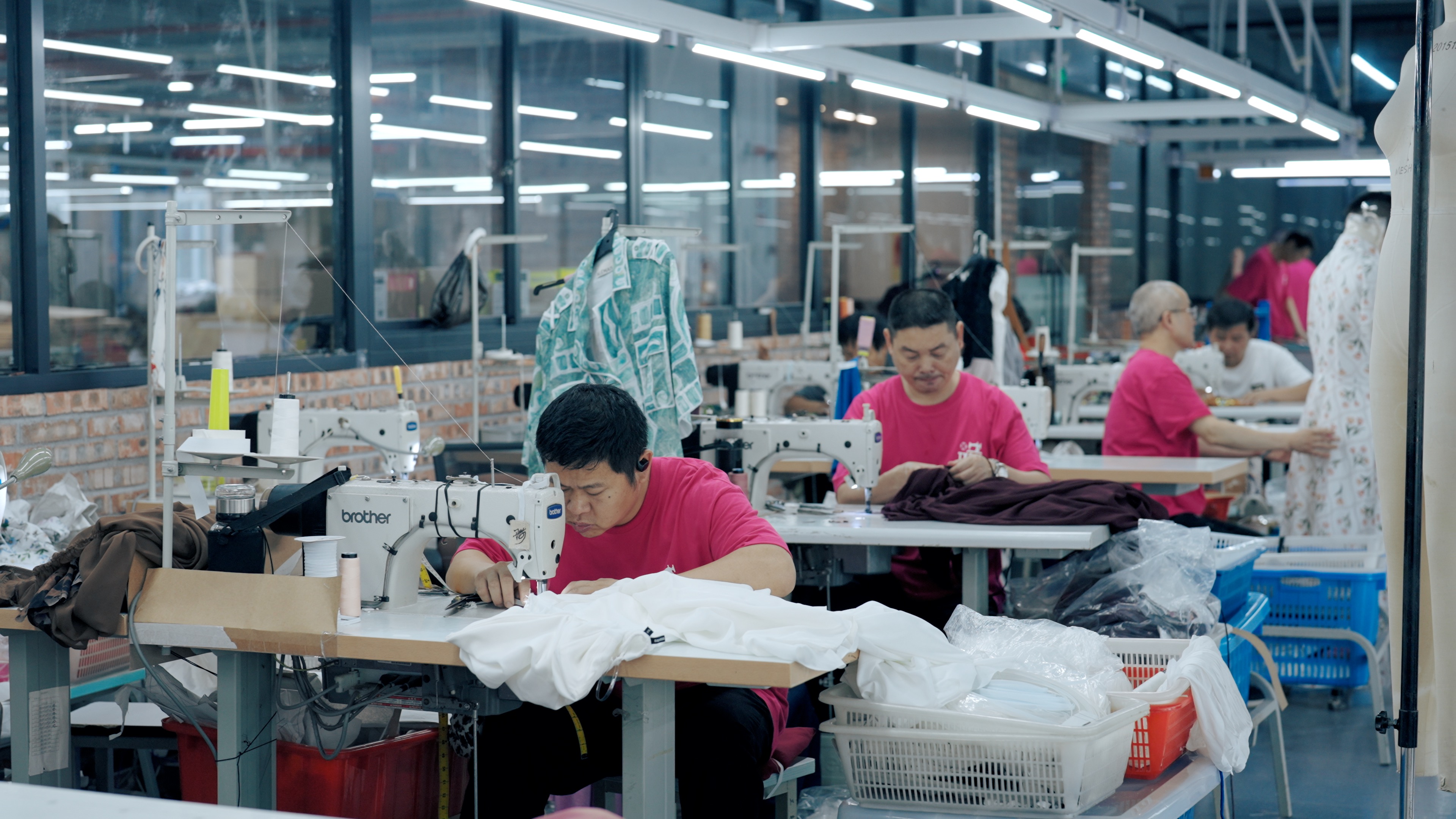 Skilled seamstresses at work in womenswear production facility
