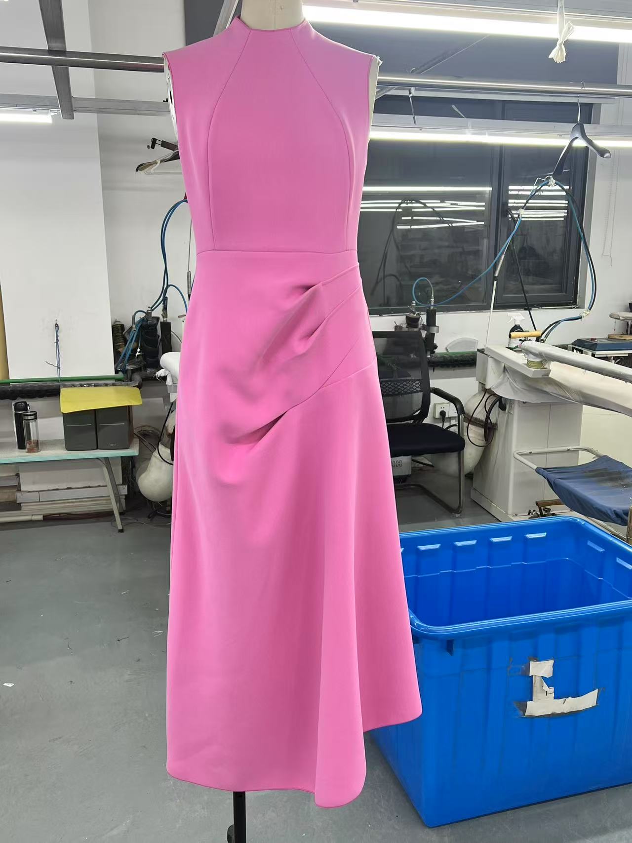 First sample of a silk dress on the dress form in Deepwove's Hangzhou workshop — the pinned fit before the founder's review. Sample turnaround at this stage runs within one week of pattern release, subject to fabric availability.