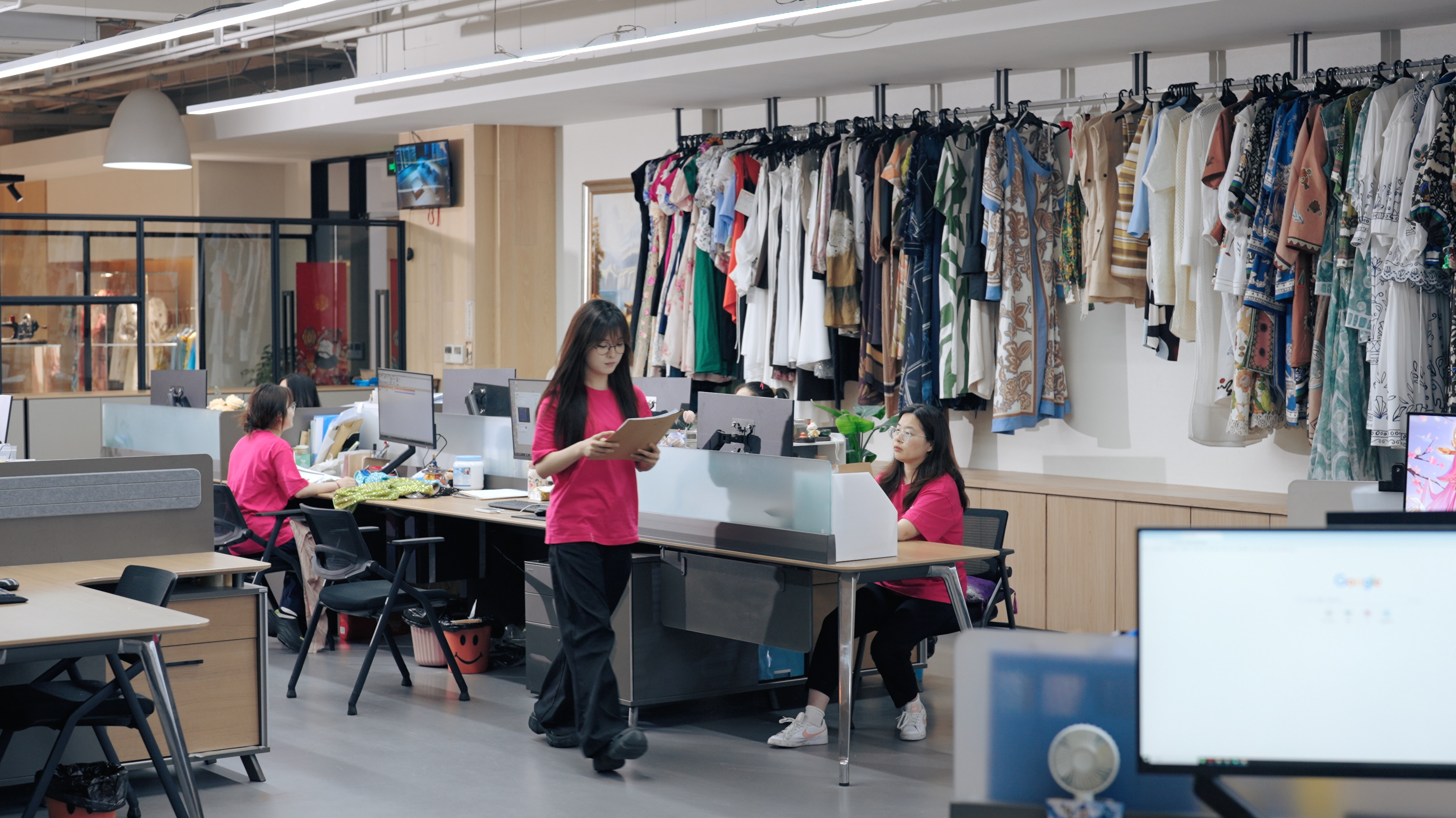 Fabric sourcing specialist reviewing fabric swatches on a development desk