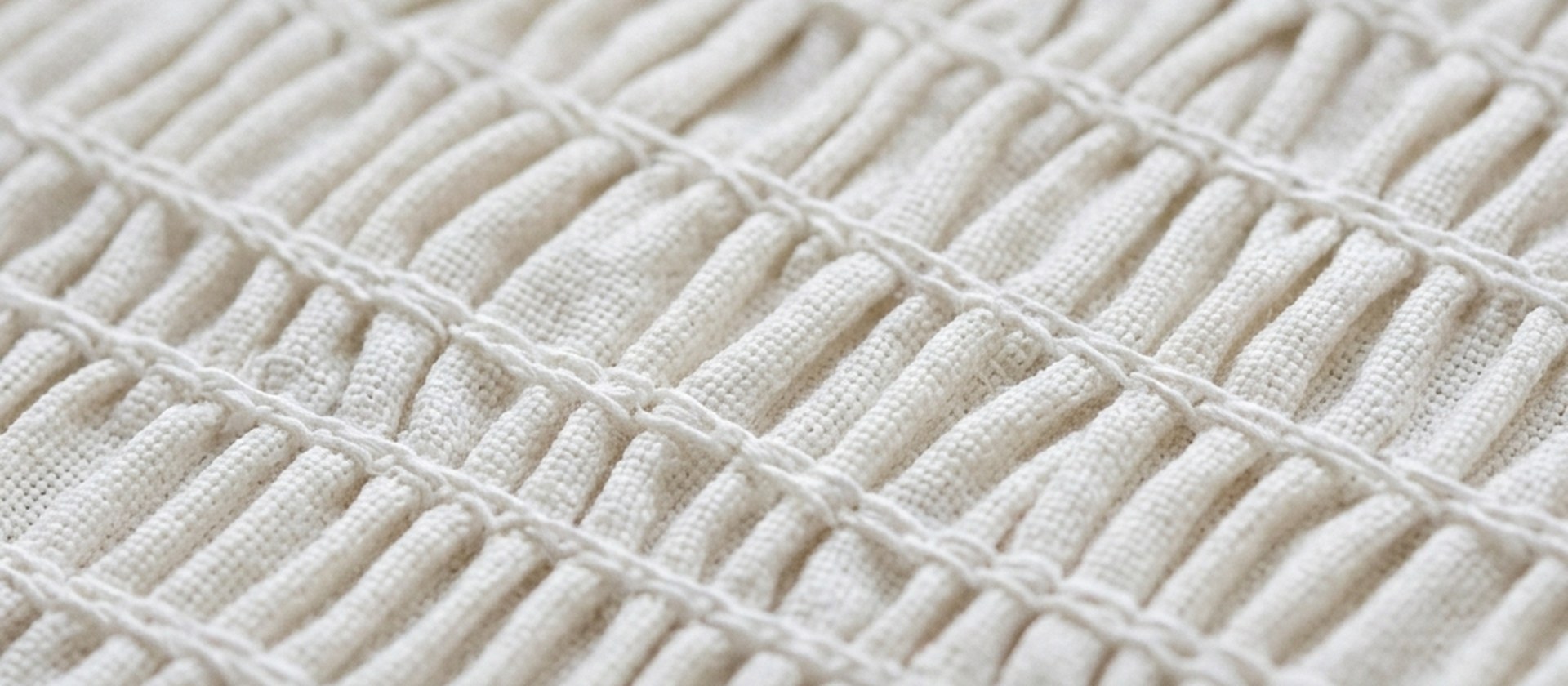 Smocked cream fabric — handcraft detail on a translated foundation silhouette